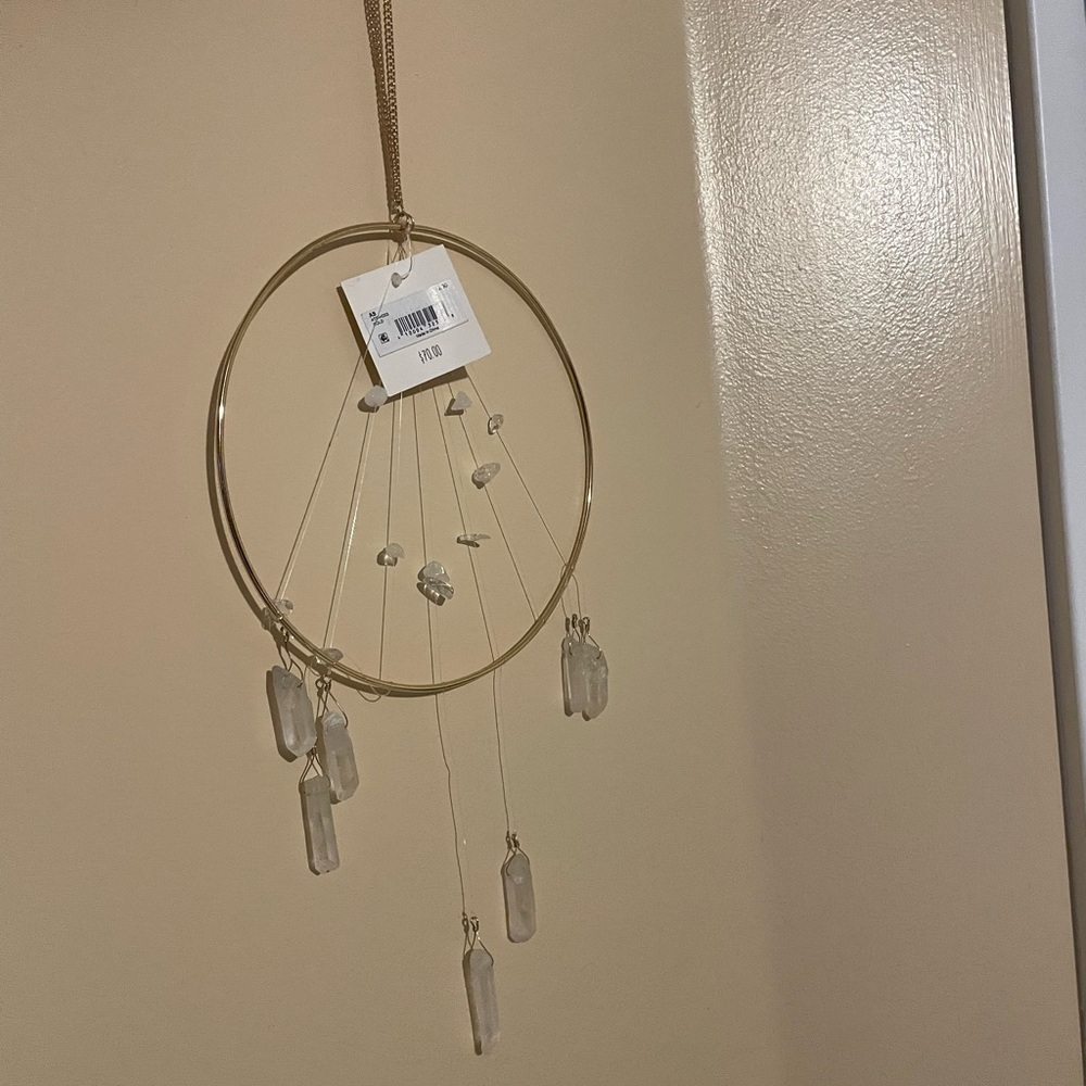 Crystal dream catcher appears to be clear quartz crystals.